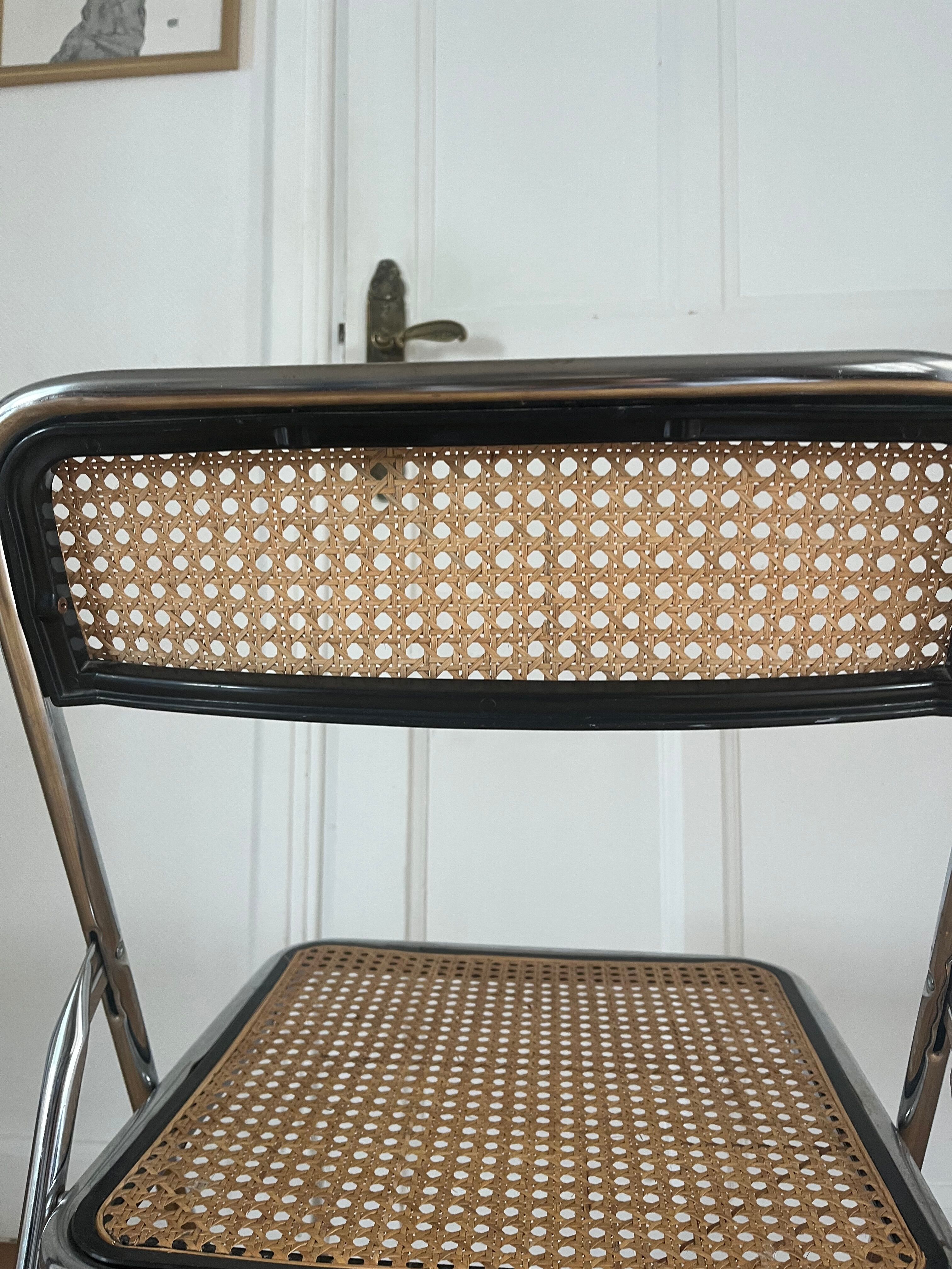 Vintage folding chair in metal and cane.