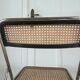 Vintage folding chair in metal and cane.