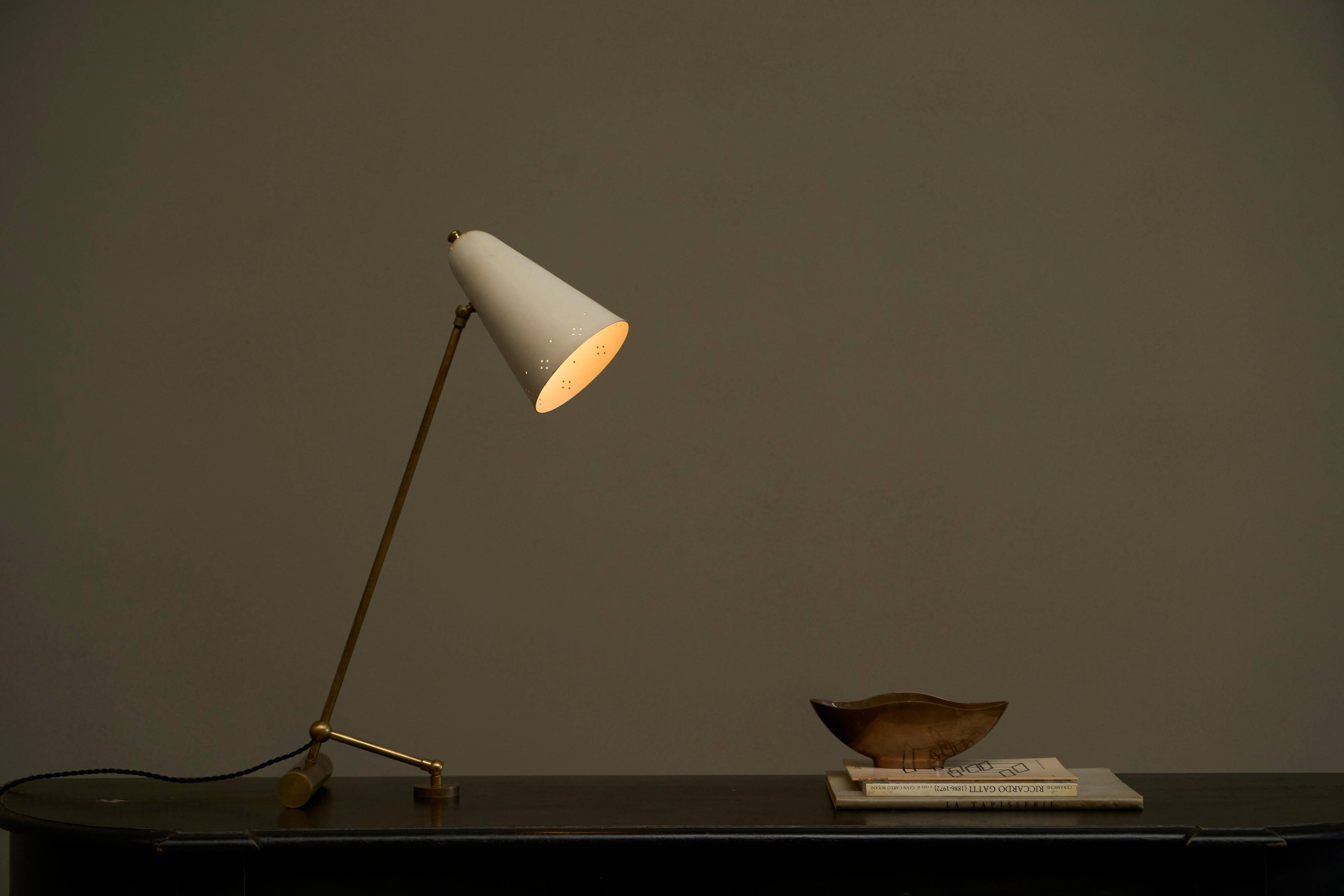 Mid Century adjustable table lamp with perforated shade from the 1950s.