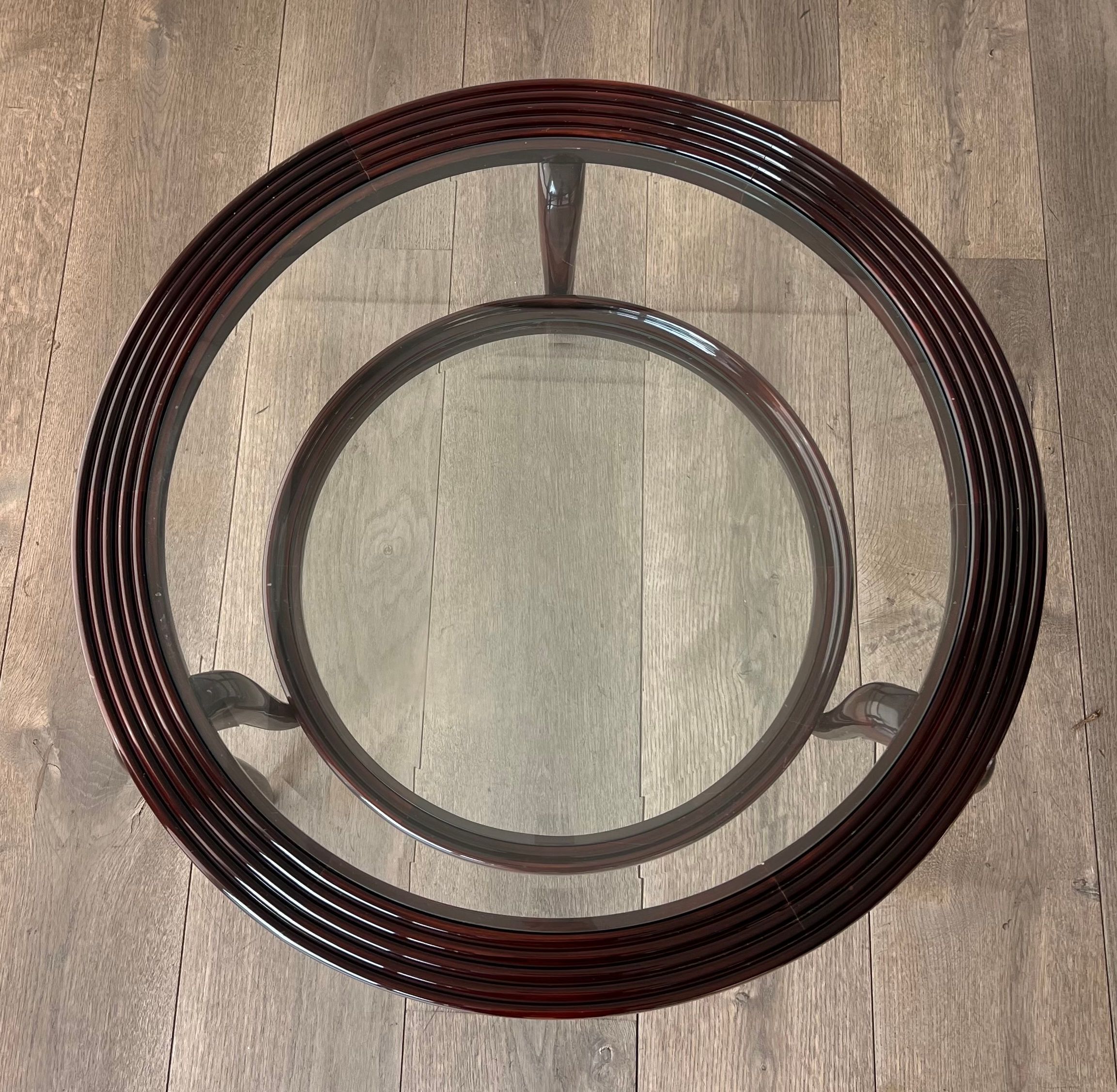 Round mid-century coffee table in walnut with a double top by Paolo Buffa.