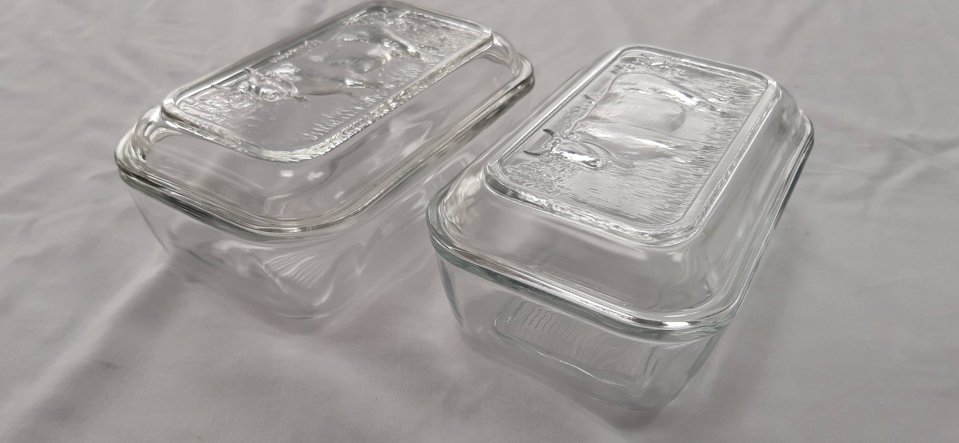Two Arcoroc glass dairy cow butter dishes