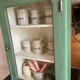 Small wooden cabinet patinated arsenic green