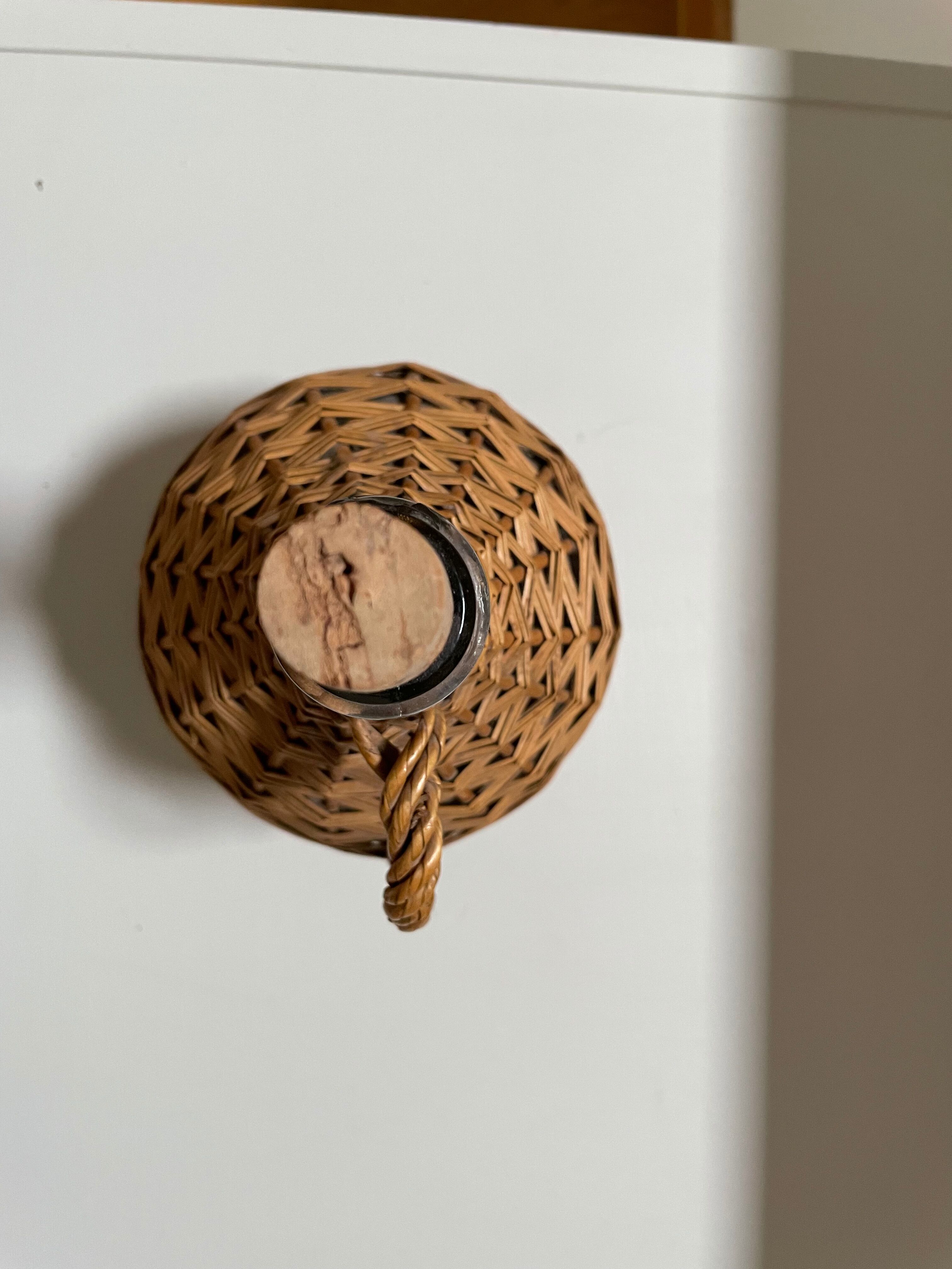 Glass bottle surrounded by wicker