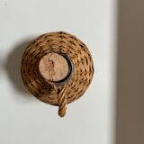 Glass bottle surrounded by wicker