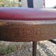 Set of 19 vintage wooden bistro chairs with red faux leather.