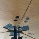 Modernist round folding dining table in wood and metal.
