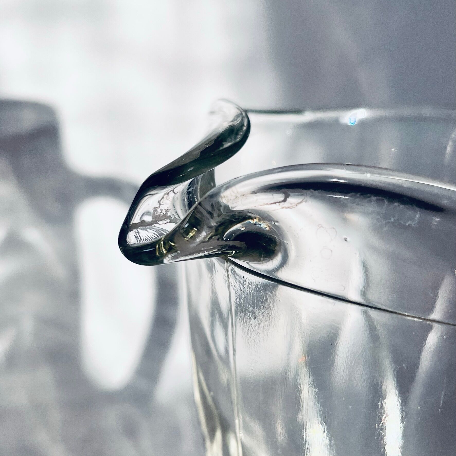 Glass pitcher on base