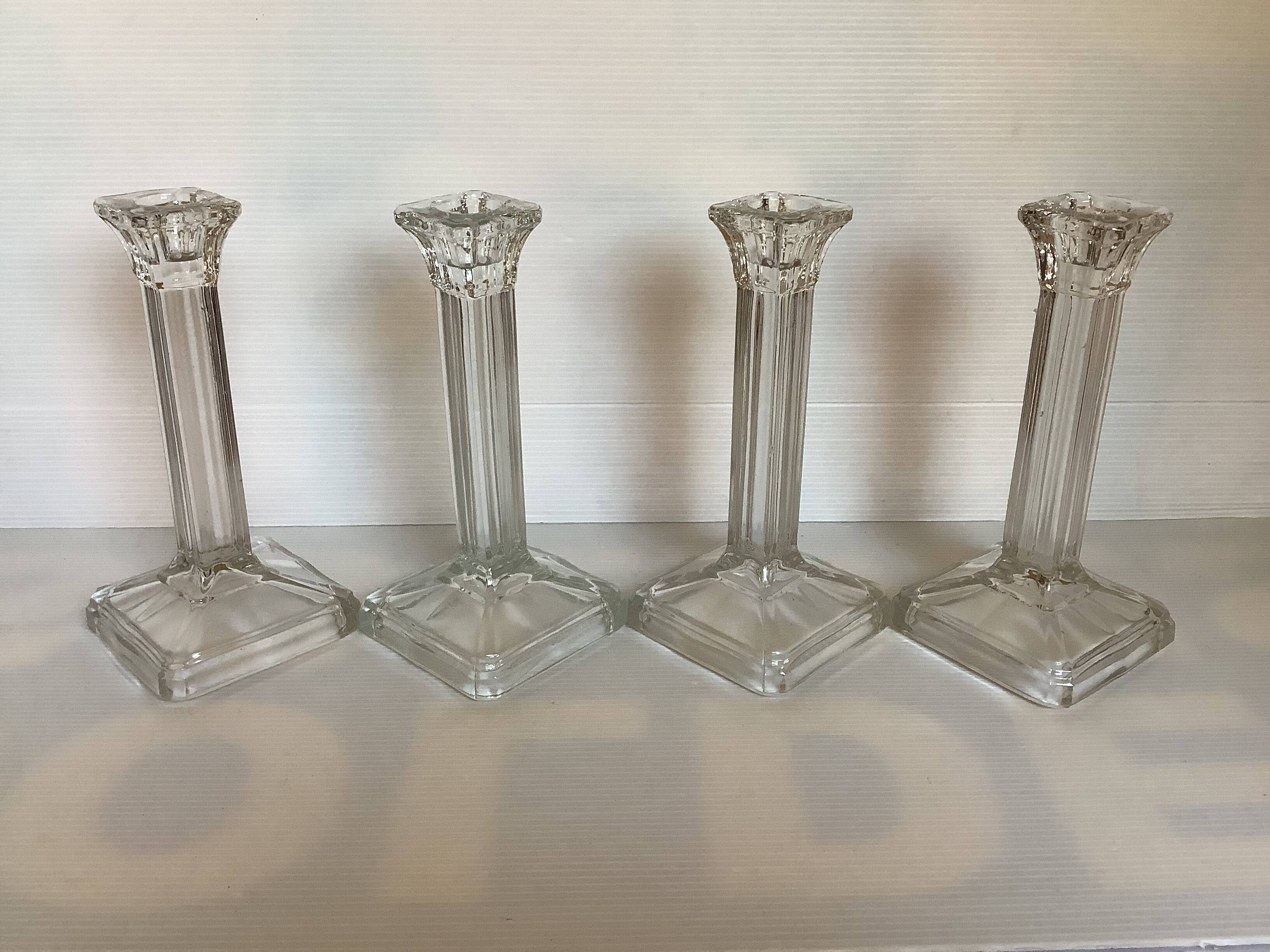 Four old square molded glass candlesticks
