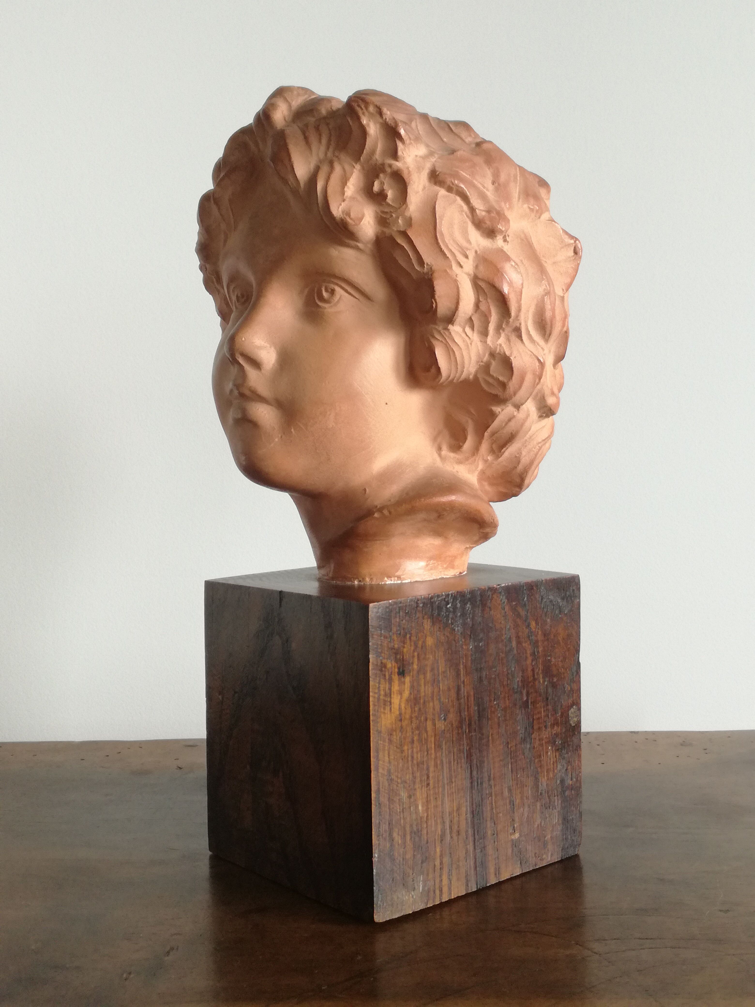 Ancient cherub bust on pedestal