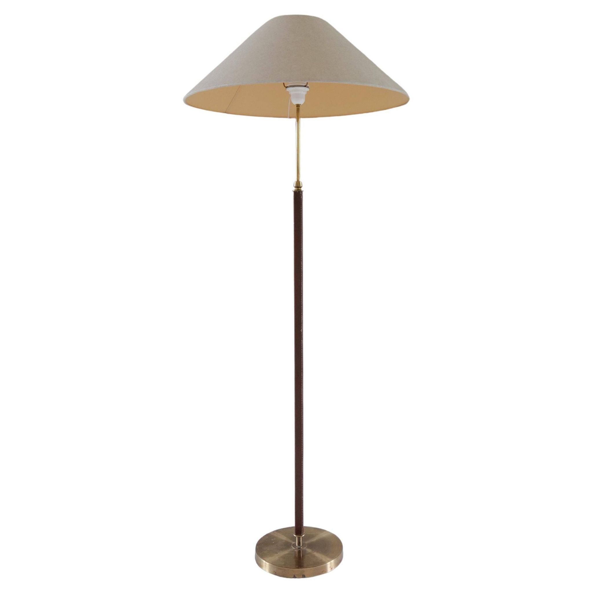 Mid-century brown leather and patinated brass floor lamp by Falkenbergs Belysning, Sweden, 1960s.