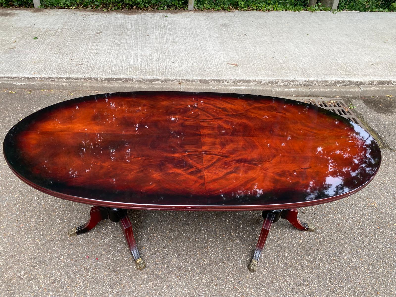 Glossy mahogany dining table in English Regency style from the 1970s.