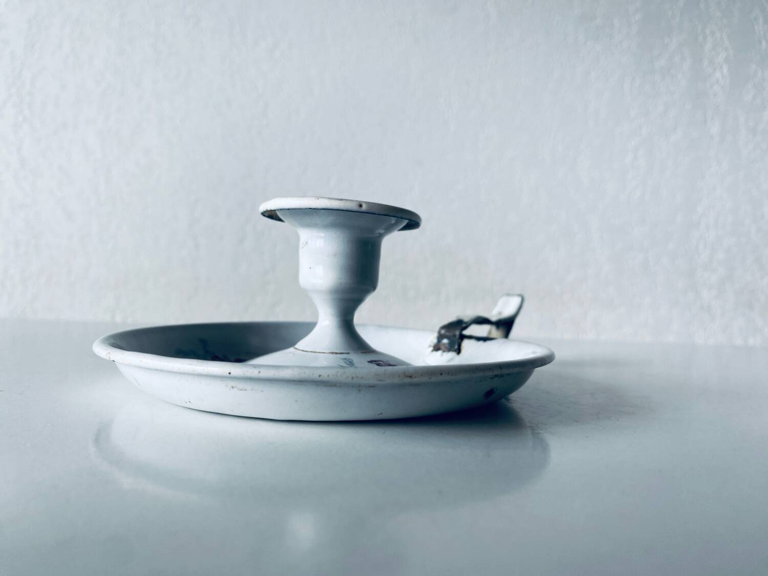 Antique enamelled metal candle holder