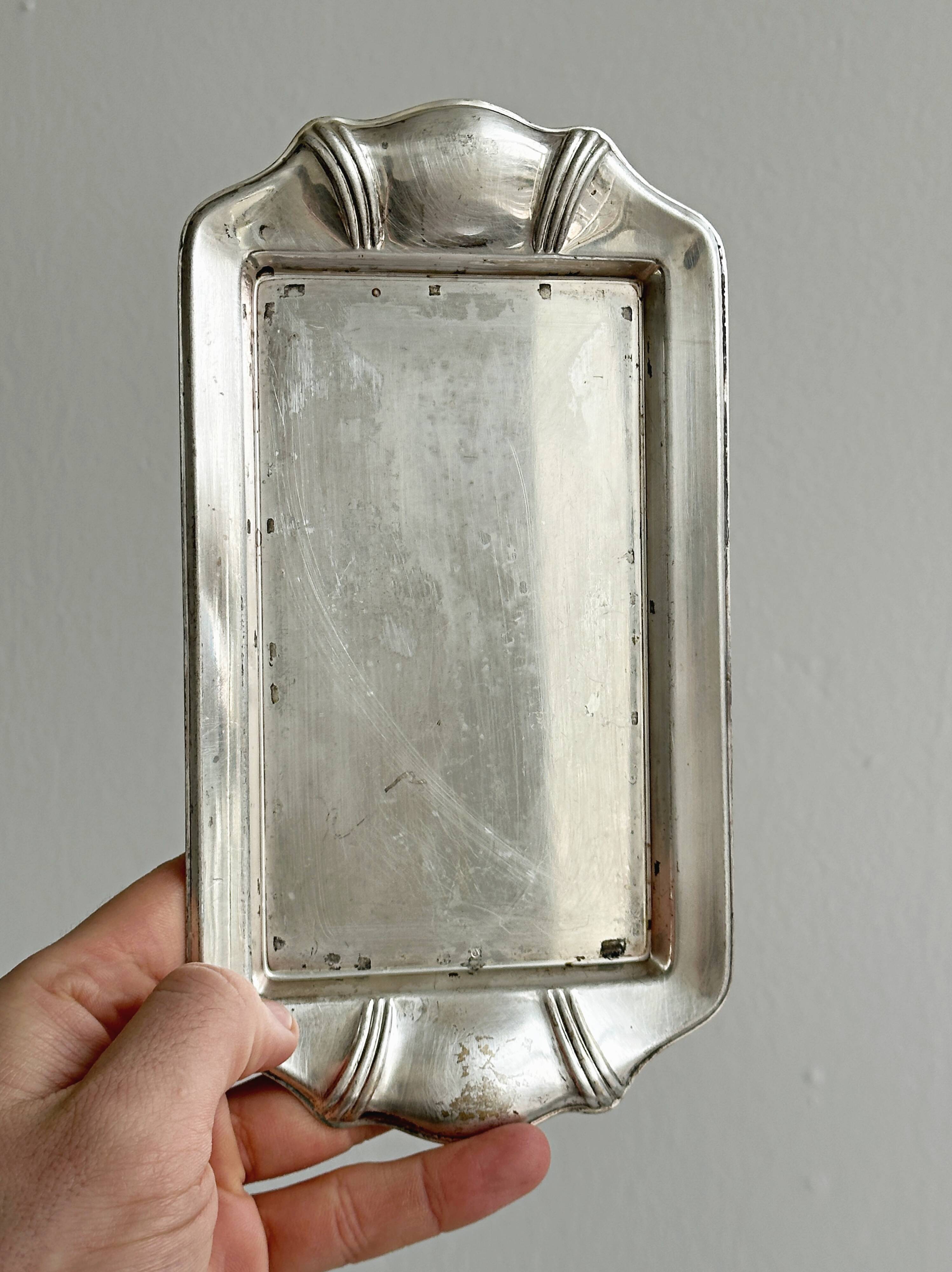 Metal butter dish and thick rectangular glass bowl.