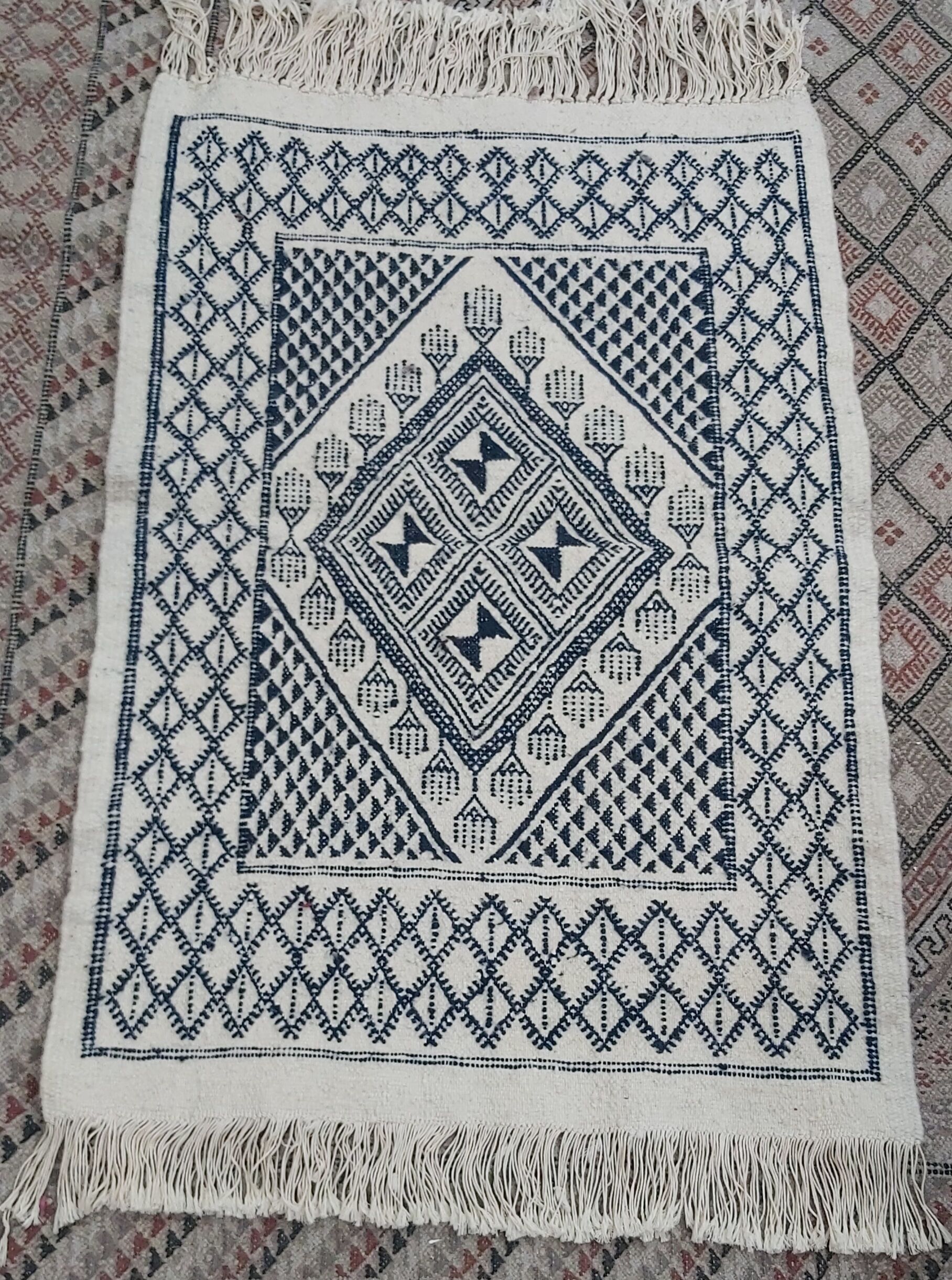 Traditional white and blue hand-woven wool carpet