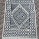 Traditional white and blue hand-woven wool carpet