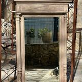 Imposing fireplace mirror in carved and painted wood, 19th century.