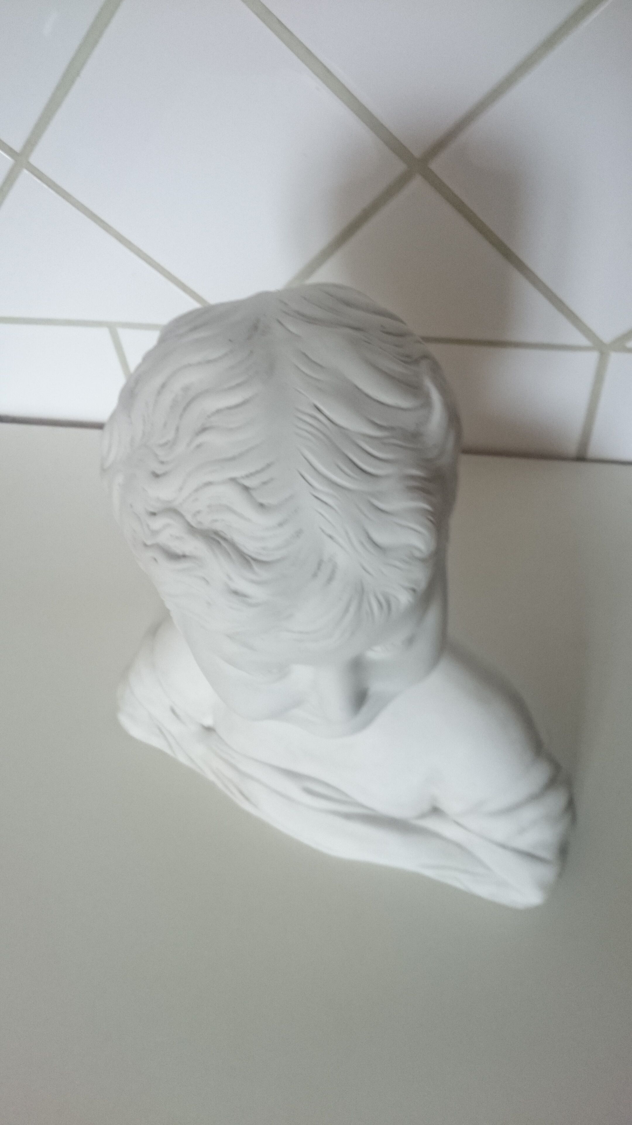 Laughing child bust after Donatello in Sèvres biscuit