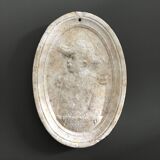 Character on plaster medallion