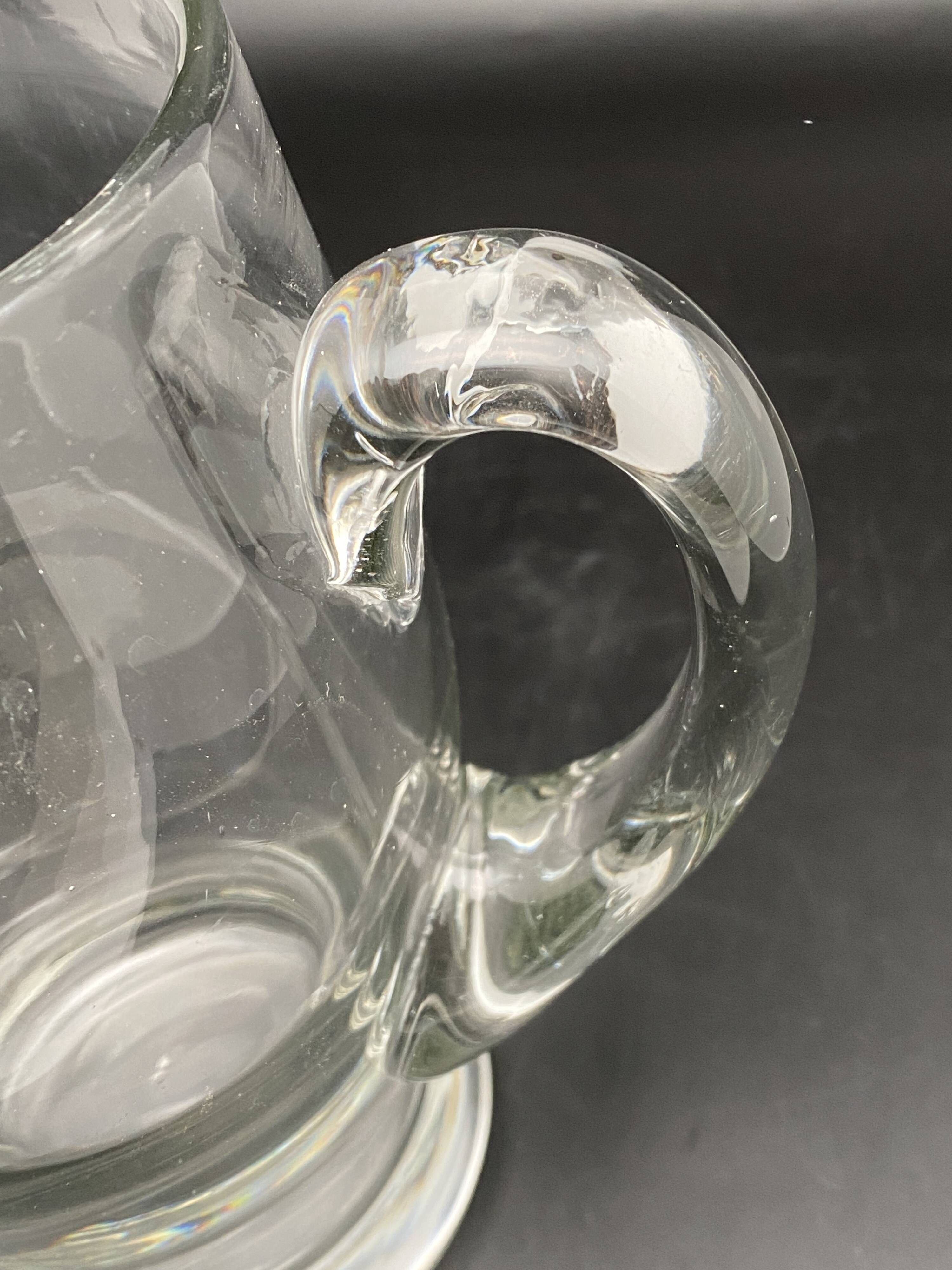 Glass jug with chiseled pattern