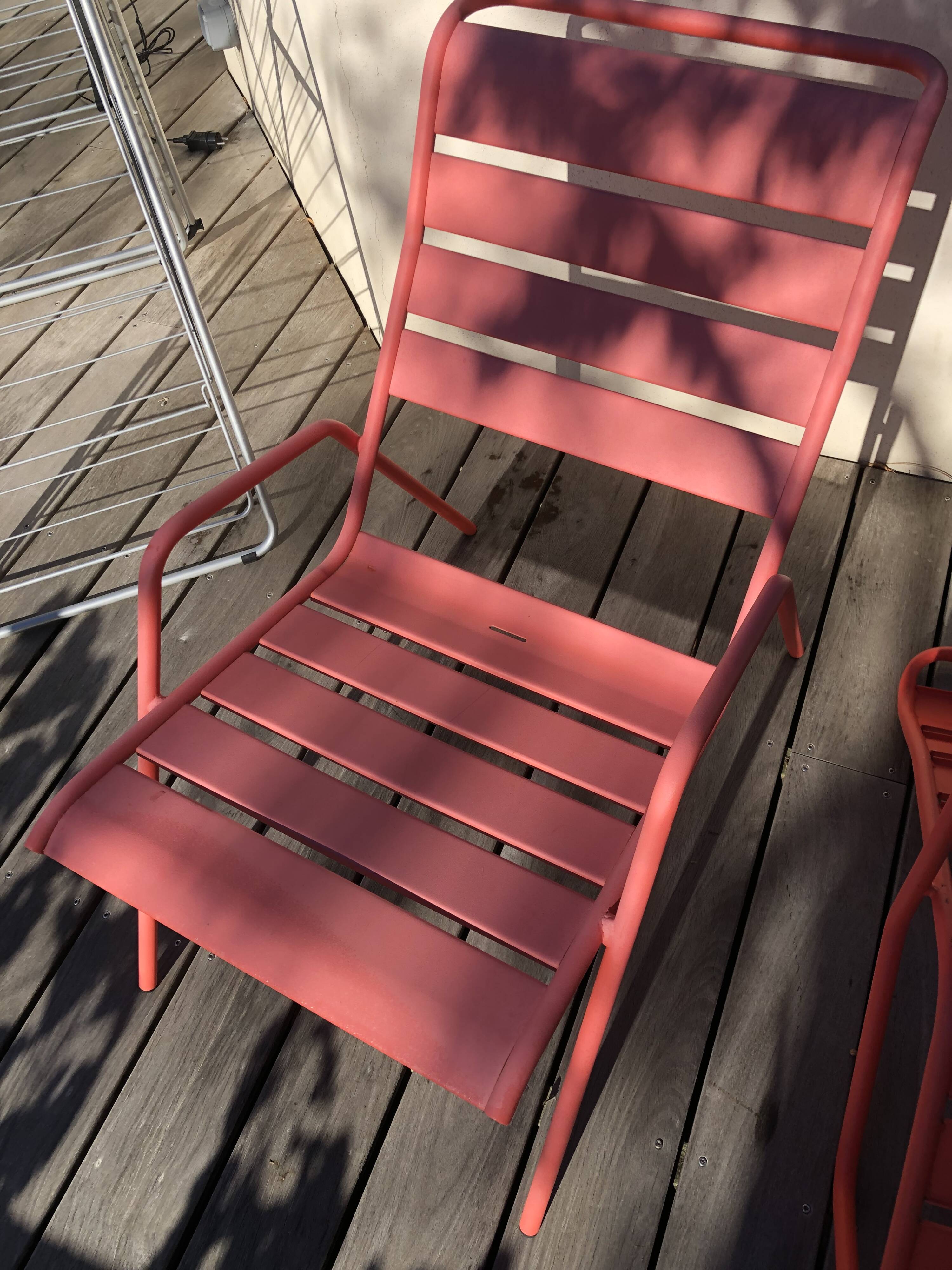 2 low chairs Fermob model Monceau in capucine colour.