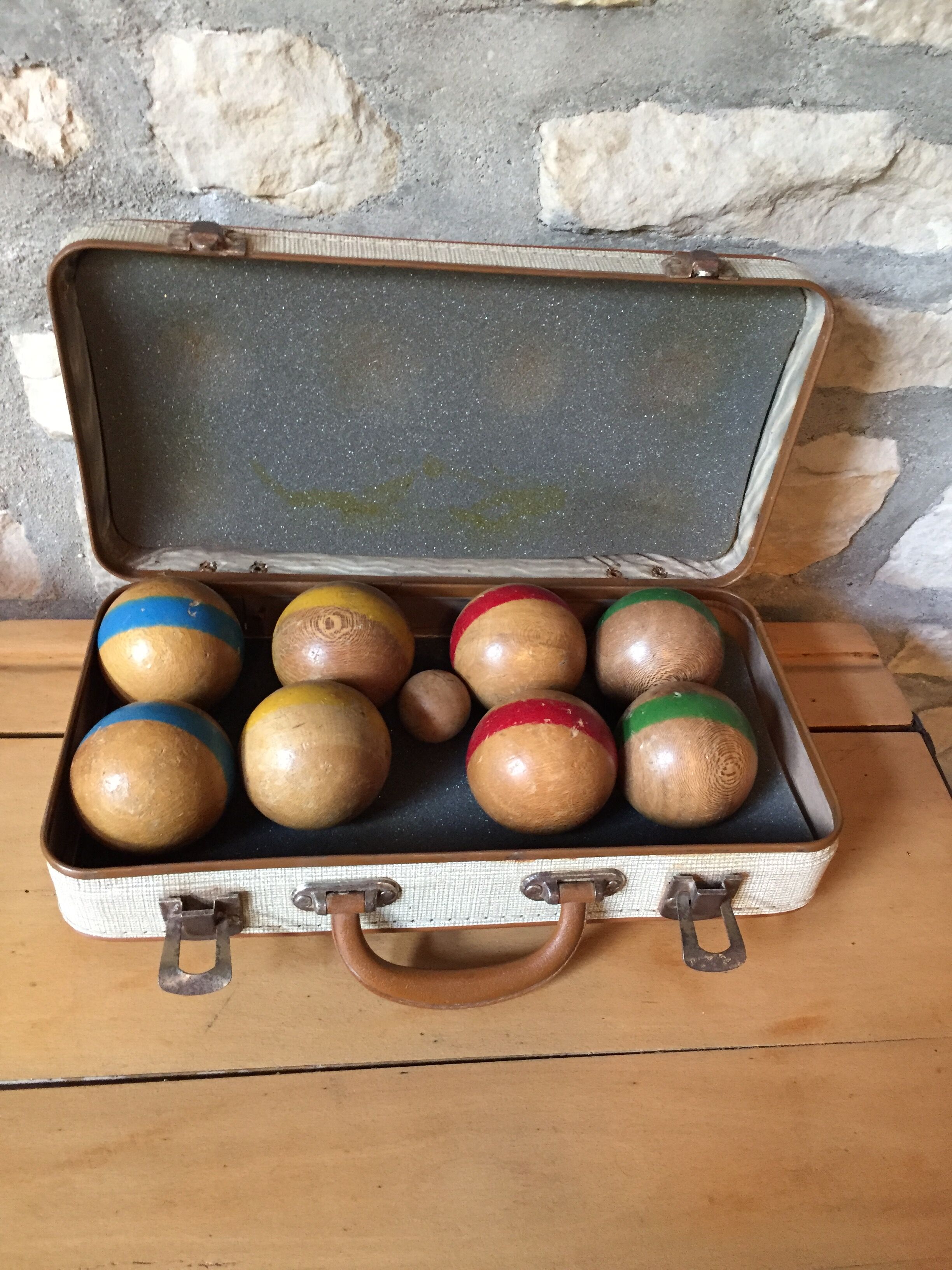 Old set of wooden balls in his suitcase