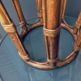 Round table in rattan and glass