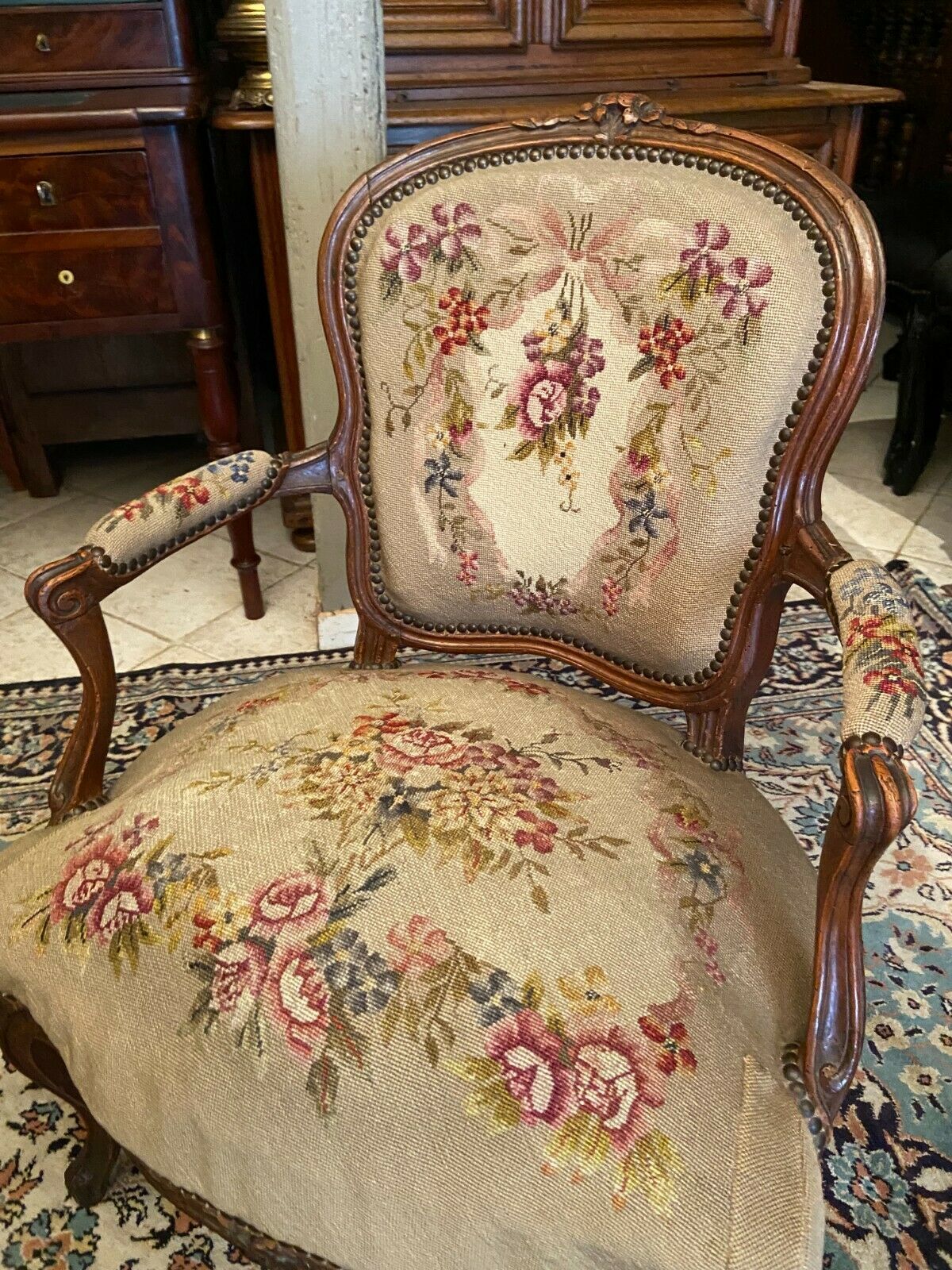 Armchair cabriolet eighteenth period Louis XV tapestry to the point floral decoration
