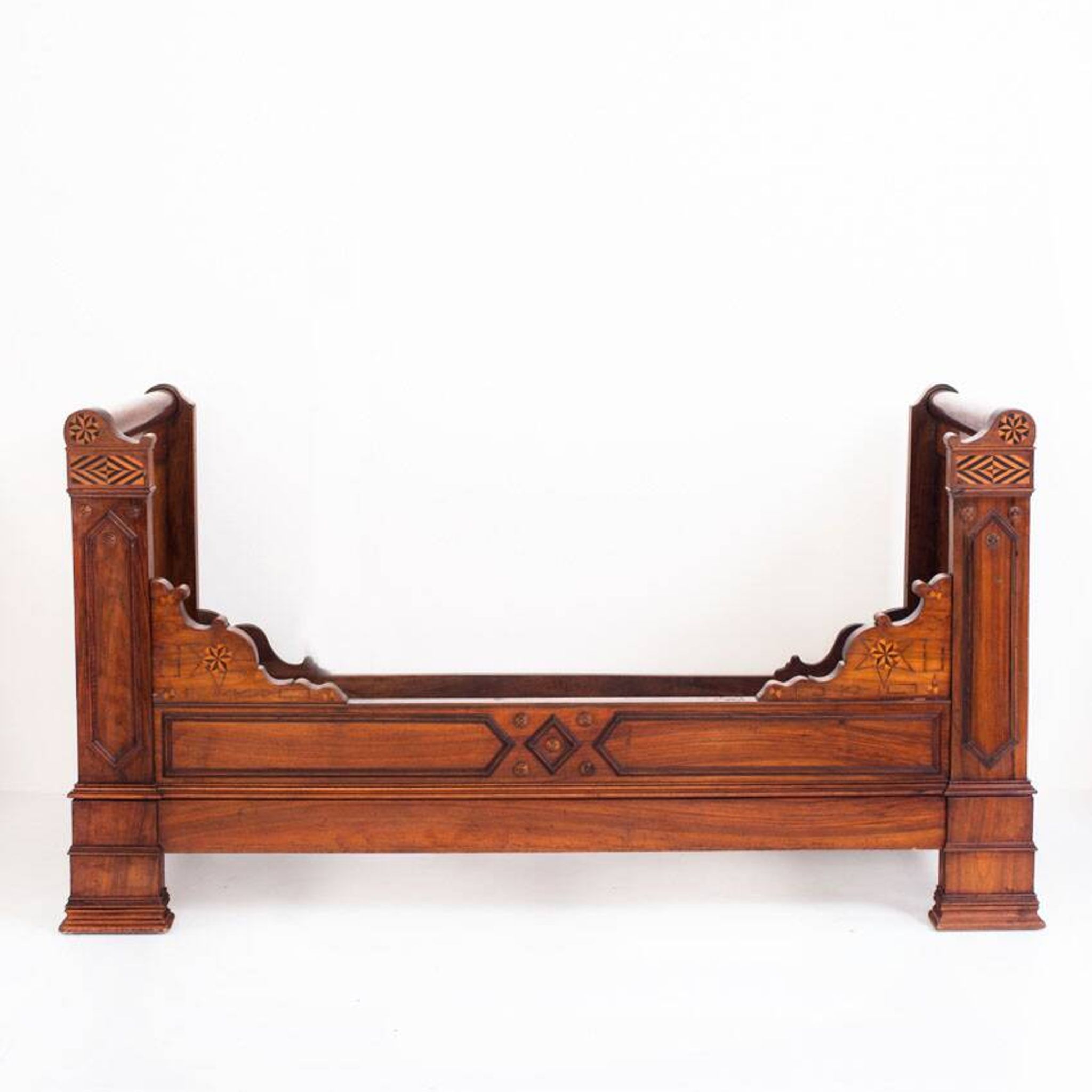 Bed made of solid walnut with marquetry details. France, 1930s.