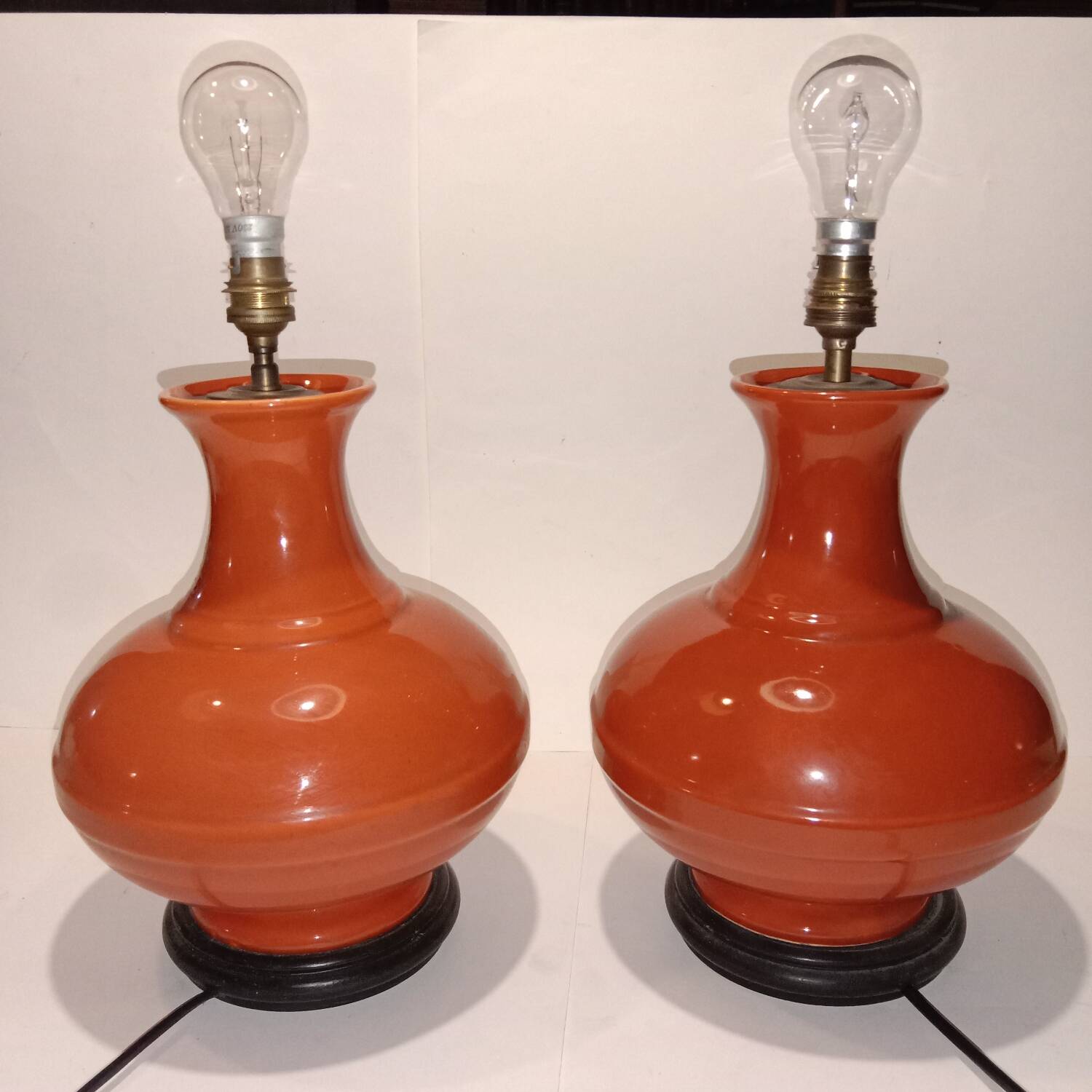 Pair of ceramic lamp bases in the shape of orange gourds.