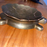 Empty brass turtle pocket