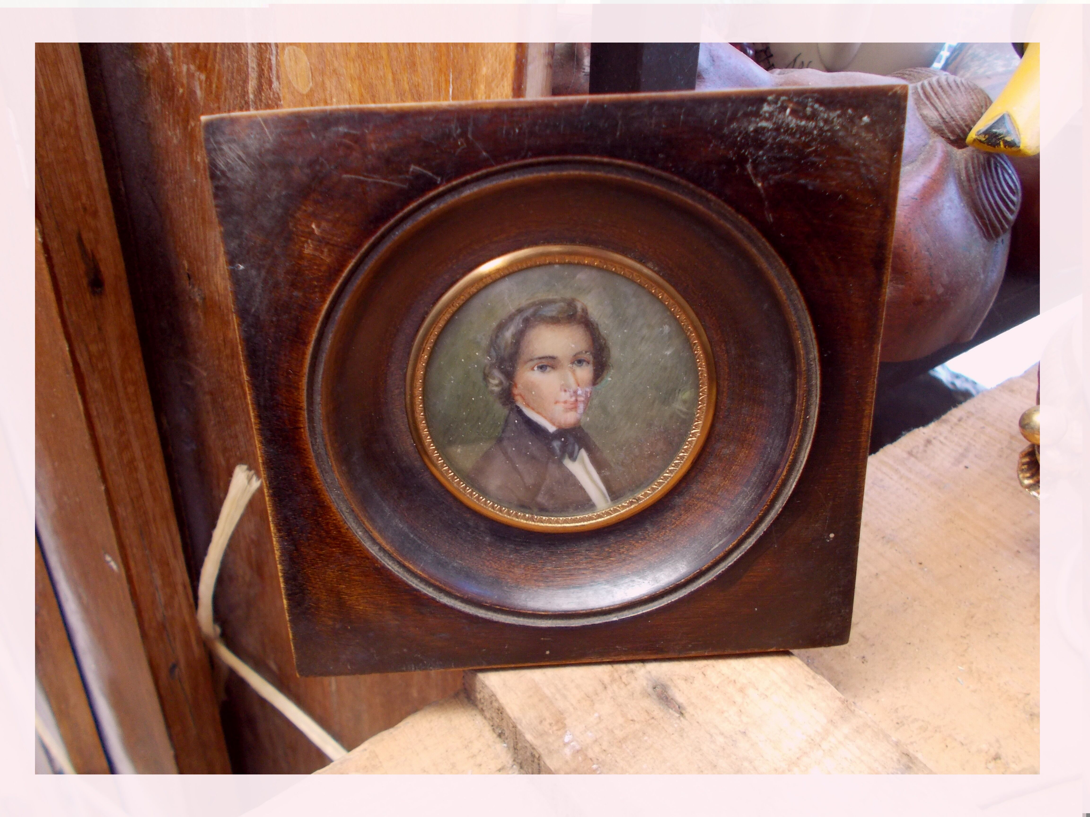 Miniature portrait of a man in a wooden frame