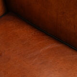 Wingback chair made of sheep leather with black piping in good condition