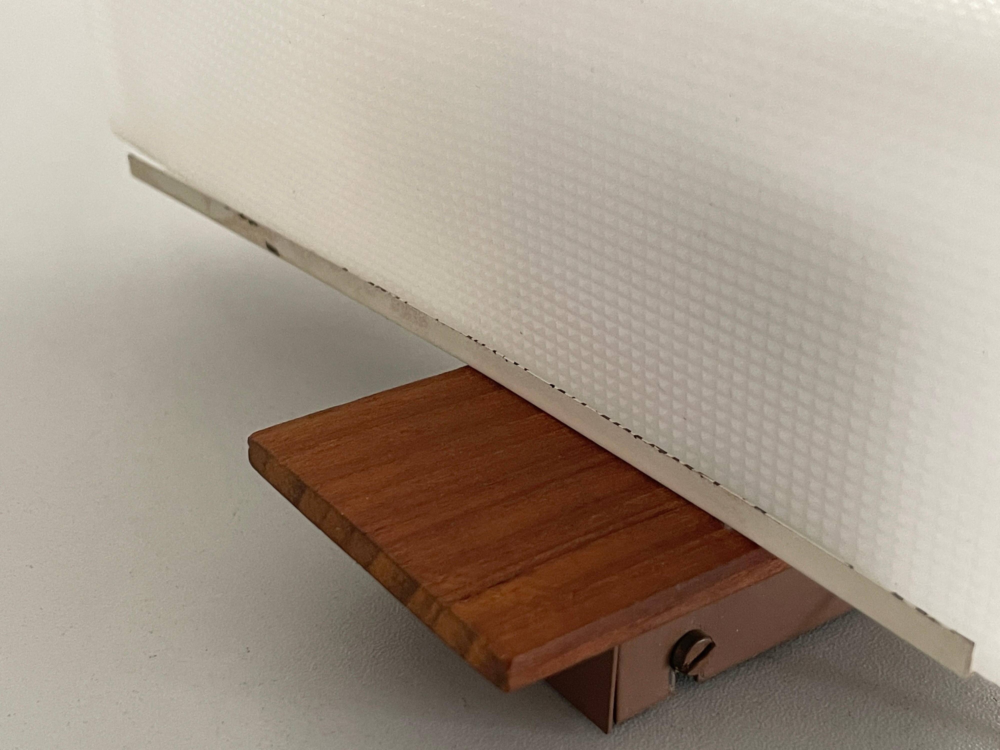 Mid-century wall lights in white plexiglass with a wooden base, 1960s, Germany.
