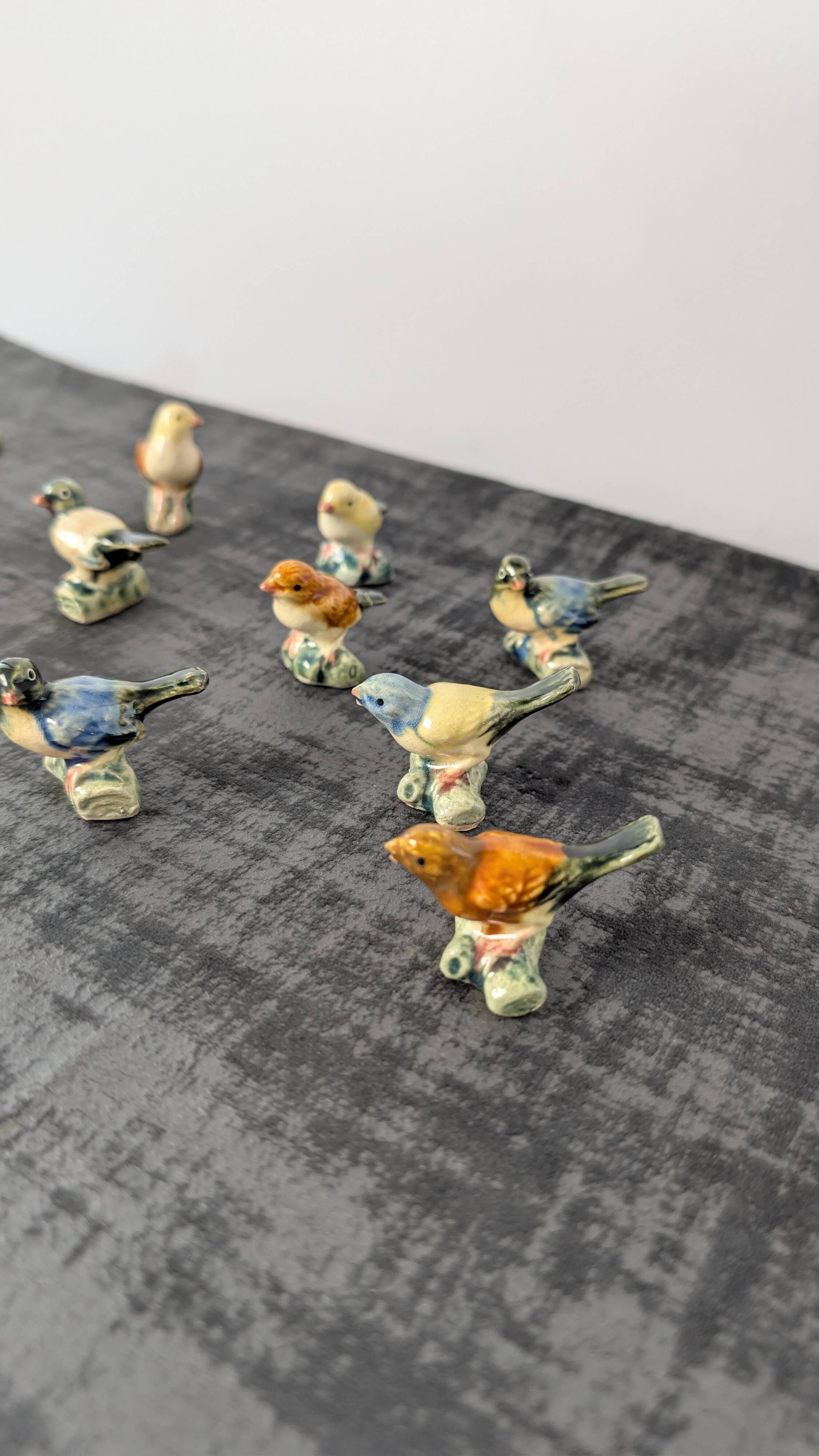 Set of 11 miniature birds in polychrome glazed ceramic.