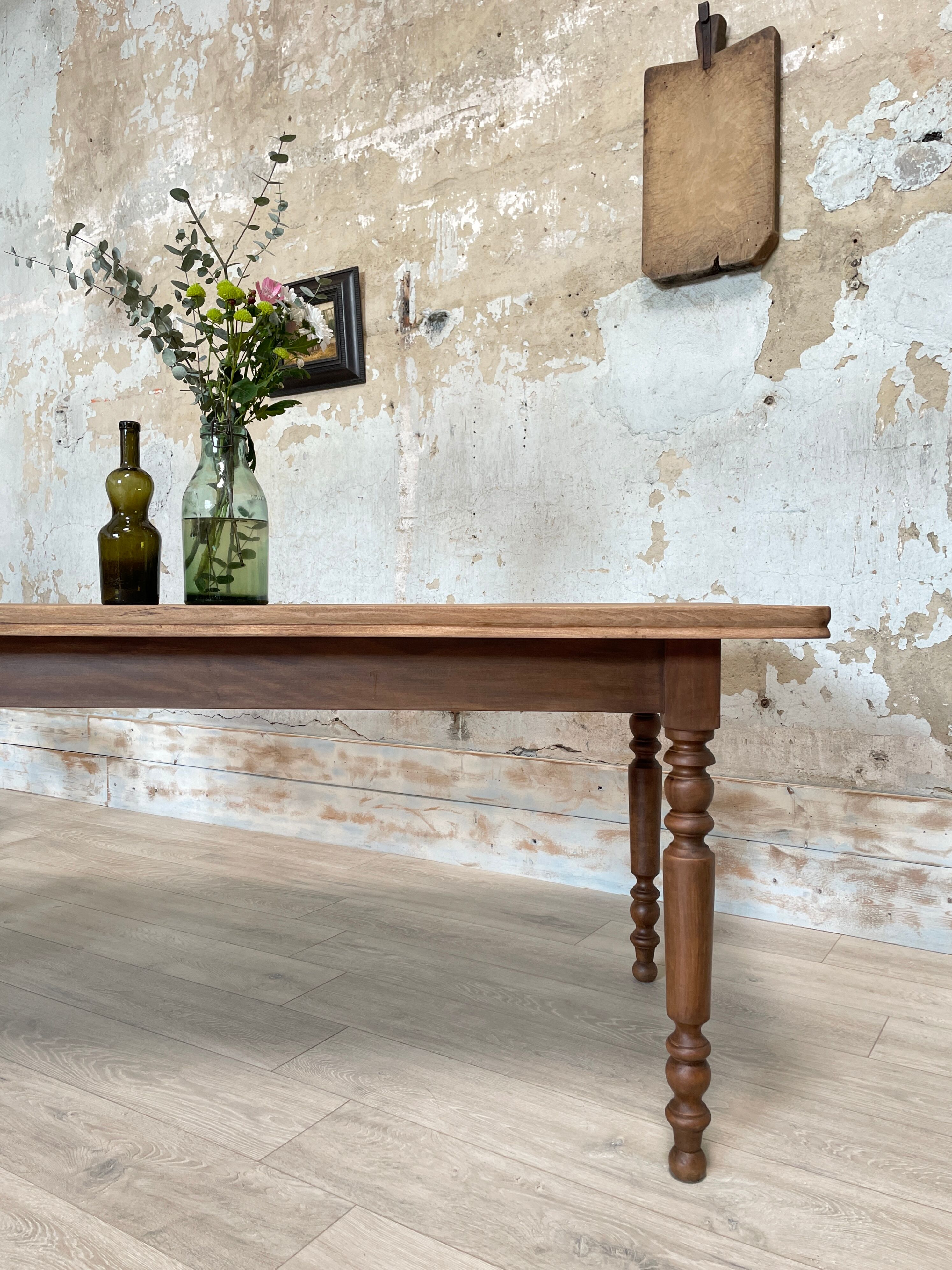 Vintage farmhouse table with turned legs.