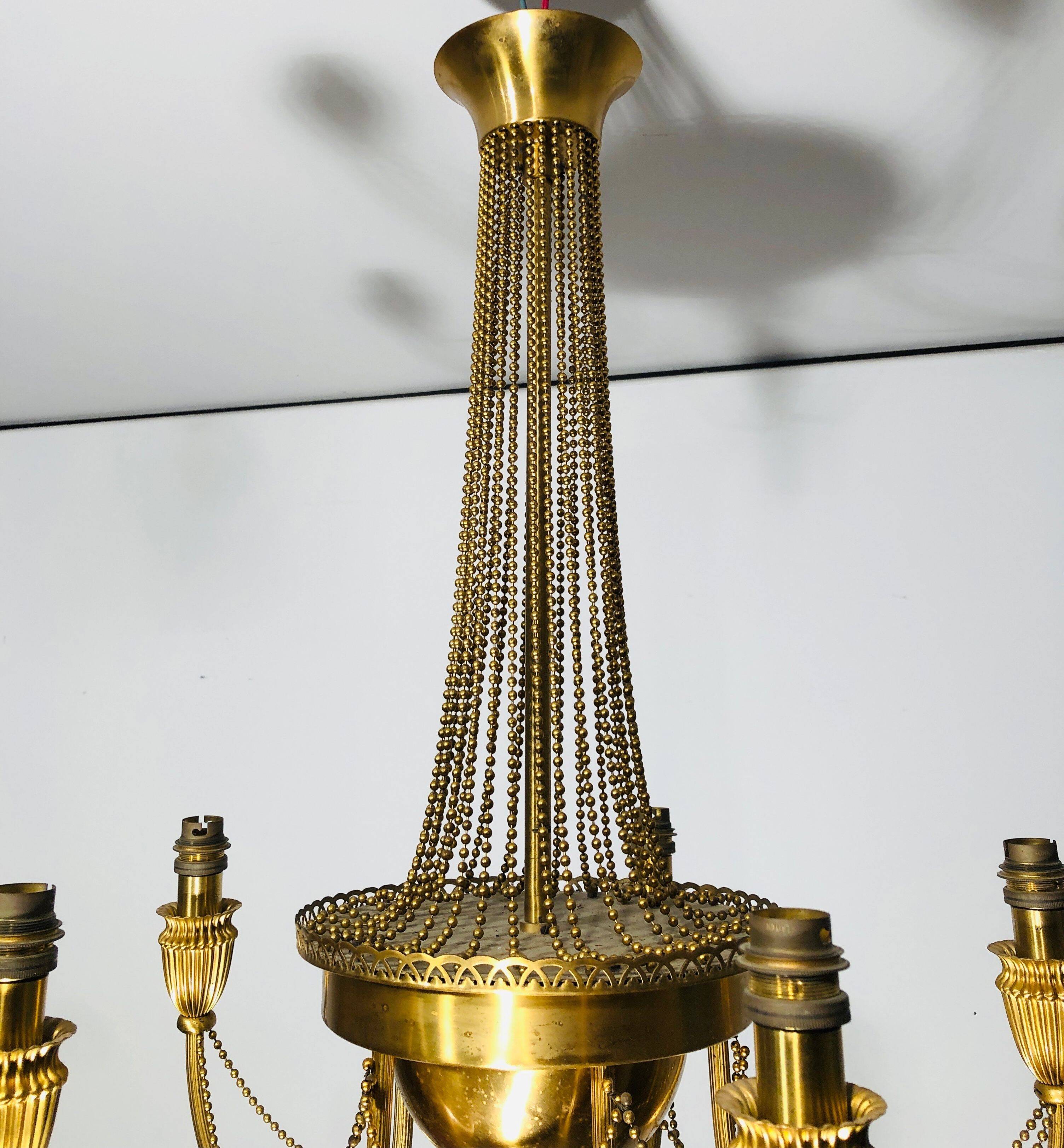 Neoclassical style brass chandelier decorated with pearl garlands