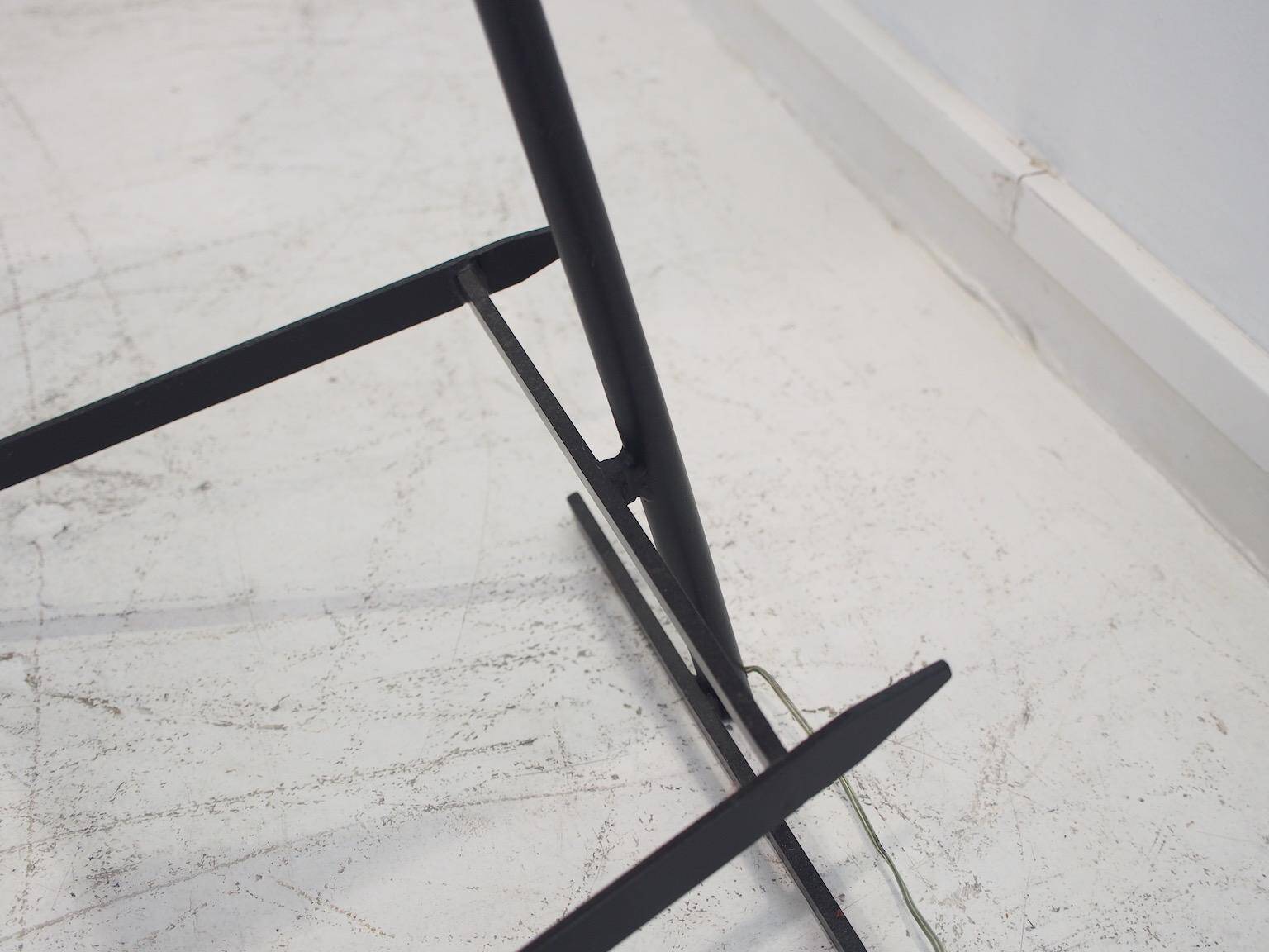 Brass and lacquered metal floor lamp with a wooden magazine shelf.