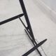 Brass and lacquered metal floor lamp with a wooden magazine shelf.