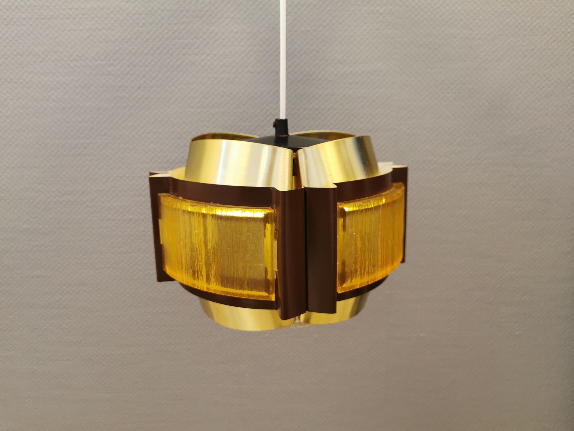 Danish hanging lamp, made in brass colored and brown metal, with yellowish hard pressed plastic deta