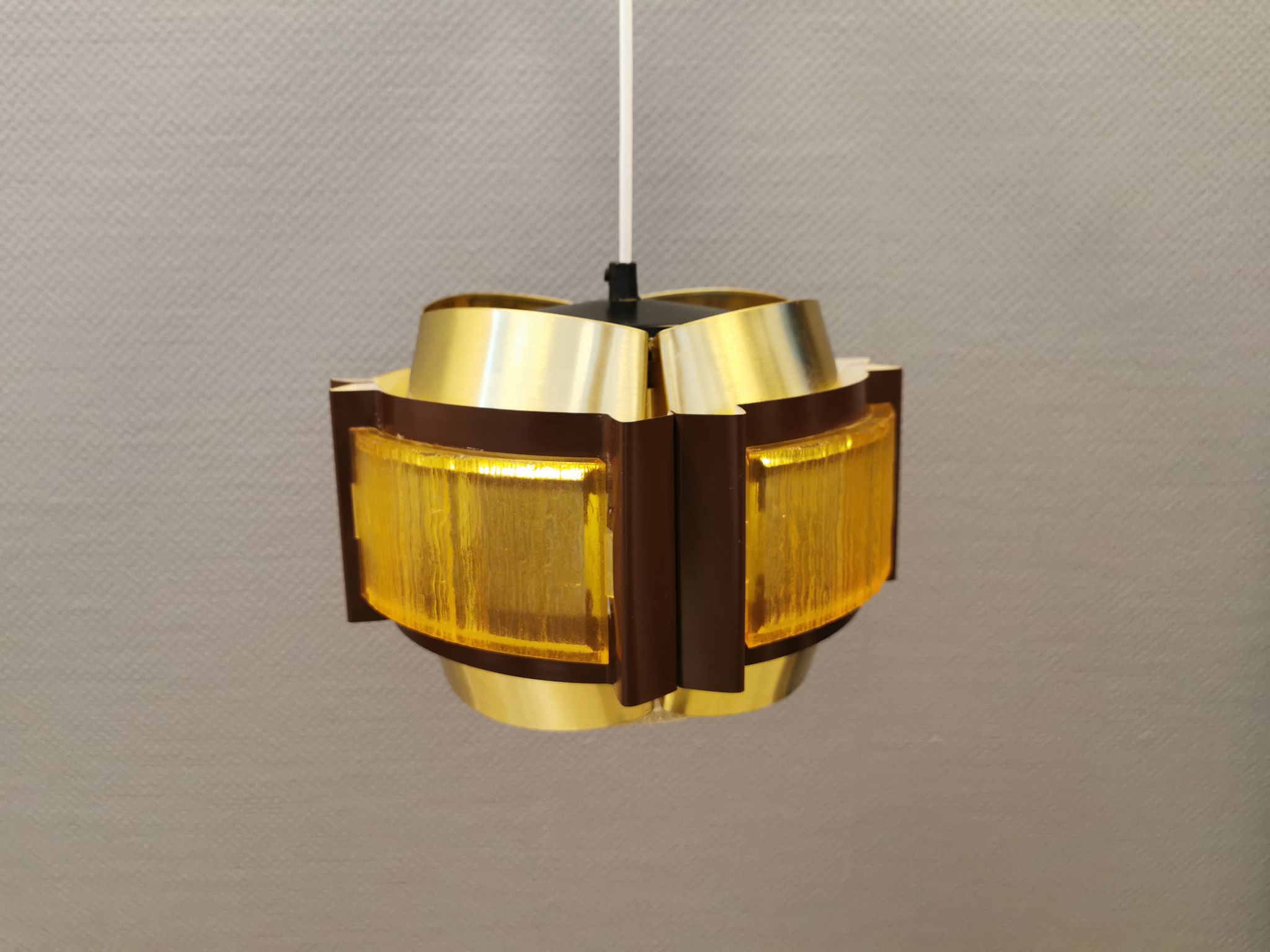 Danish hanging lamp, made in brass colored and brown metal, with yellowish hard pressed plastic deta