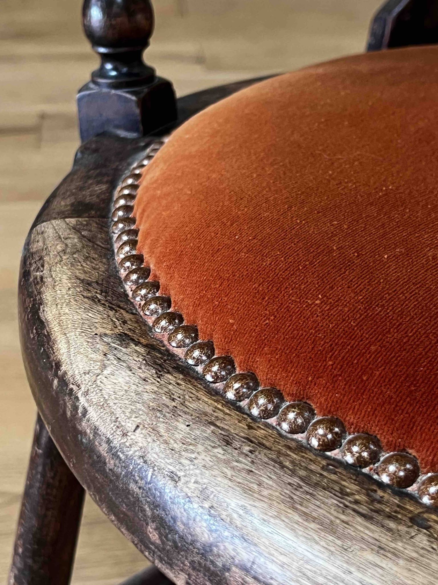 Windsor chair with comb back, stained wood and terracotta velvet.