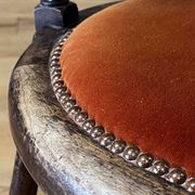 Windsor chair with comb back, stained wood and terracotta velvet.