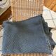 Blue crocheted bedspread and its vintage cushion