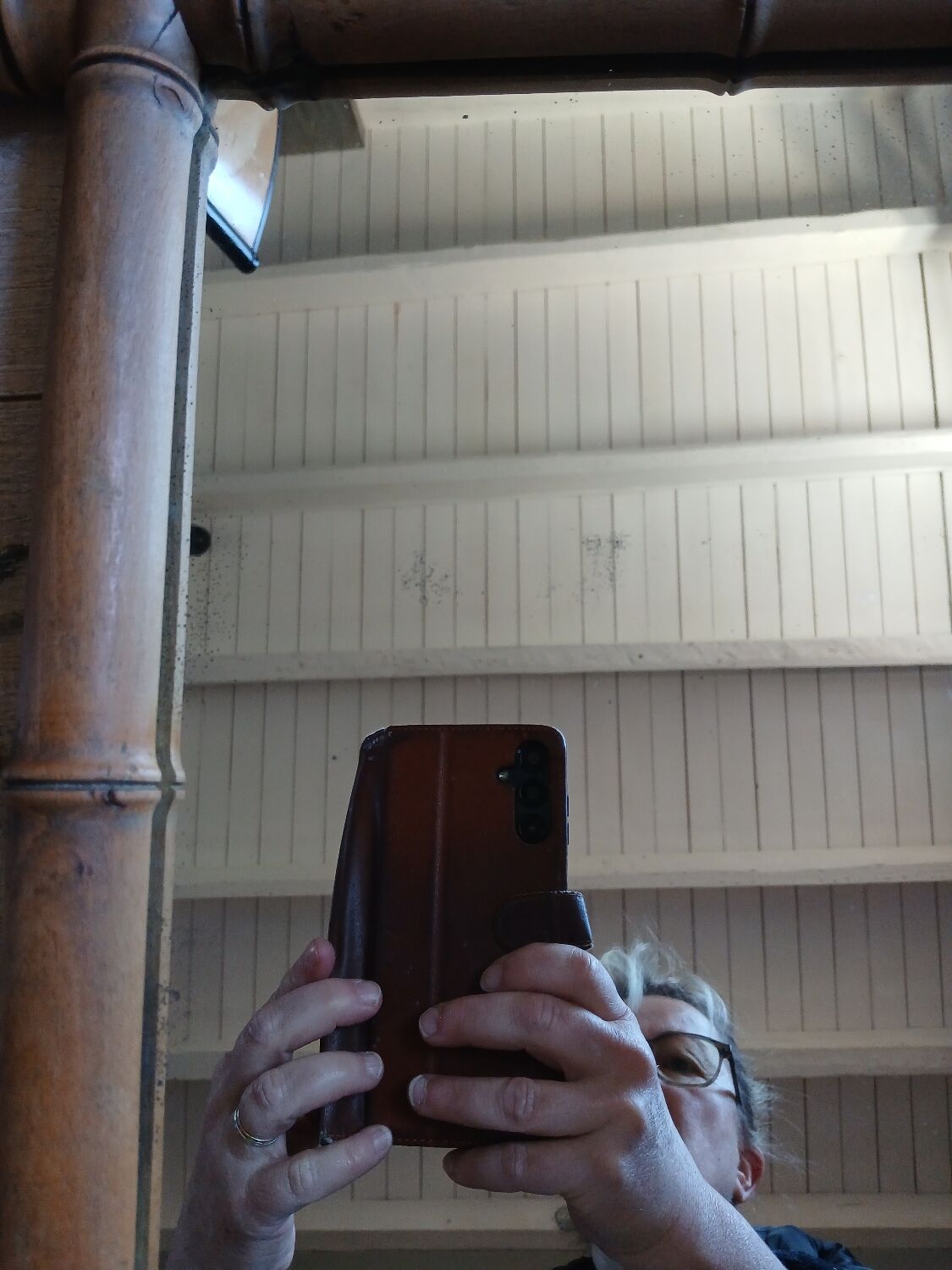 Antique wall mirror with a wooden frame