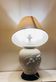 1980s ceramic table lamp with a wooden base and adjustable shade.