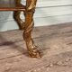 Golden wooden console, four legs adorned with sea monsters, purple breccia marble, around 1900.