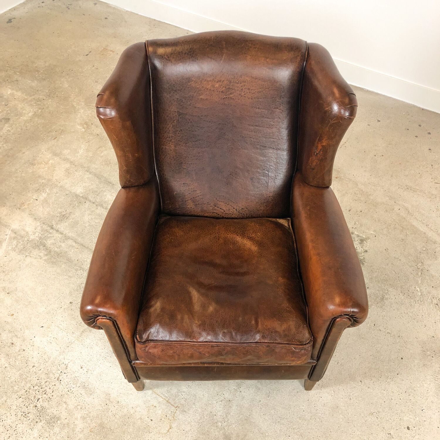 Dark brown sheep leather wingback armchair