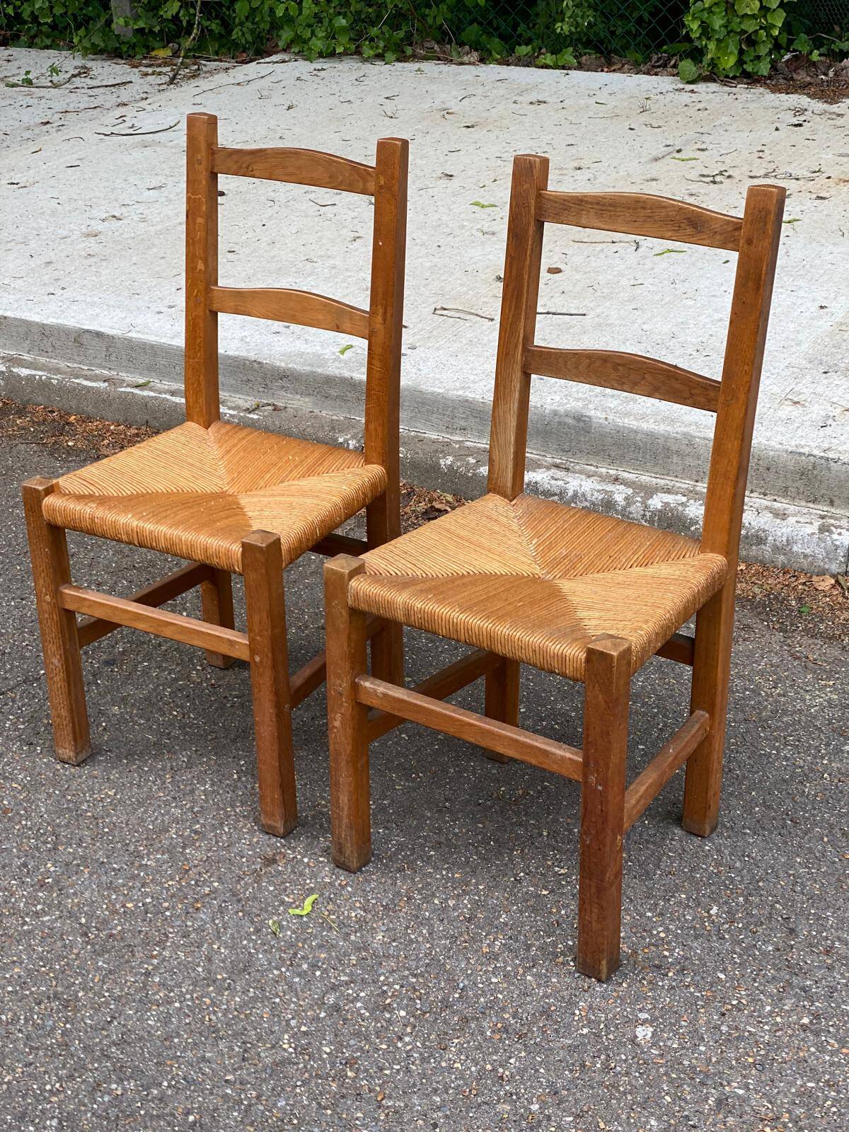 2 solid wood and straw chairs