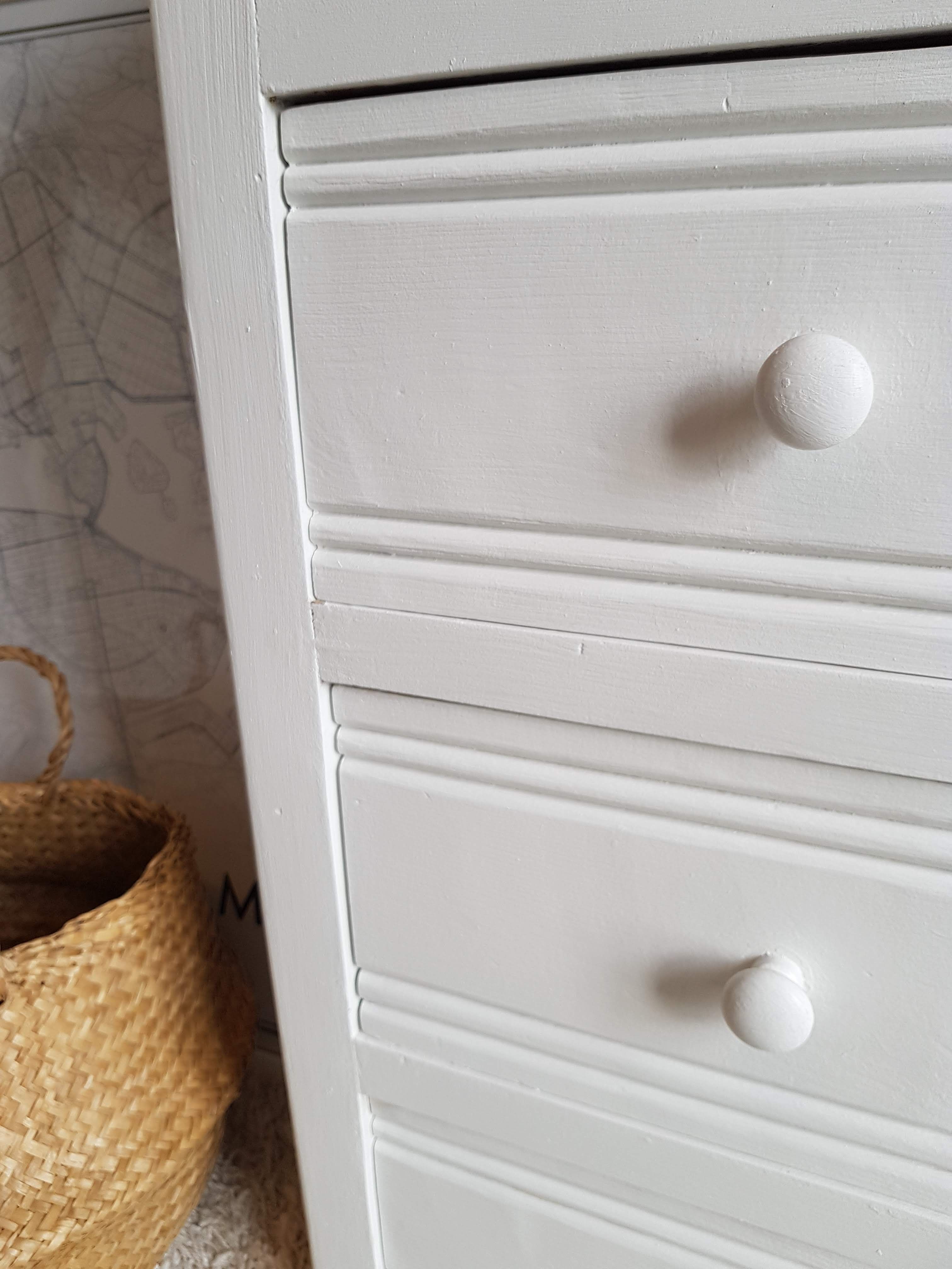 Old white asymmetrical chest of drawers