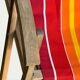 Vintage deck chair with red and orange striped fabric, original patina.